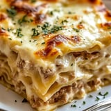 Stack of cheesy lasagna with meat layers