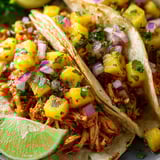 A dish with pineapple on top of food.