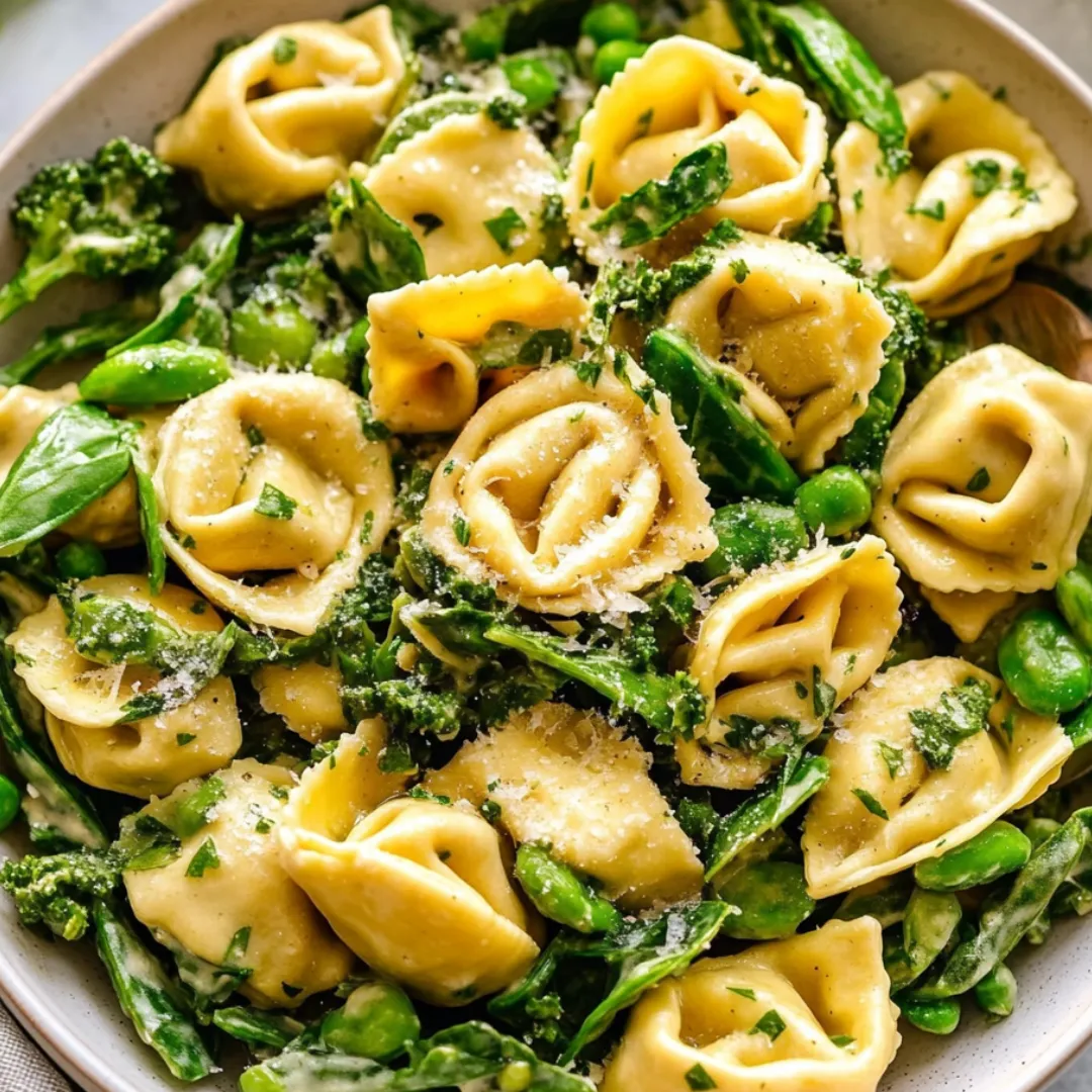 A bowl of pasta with green beans and cheese.