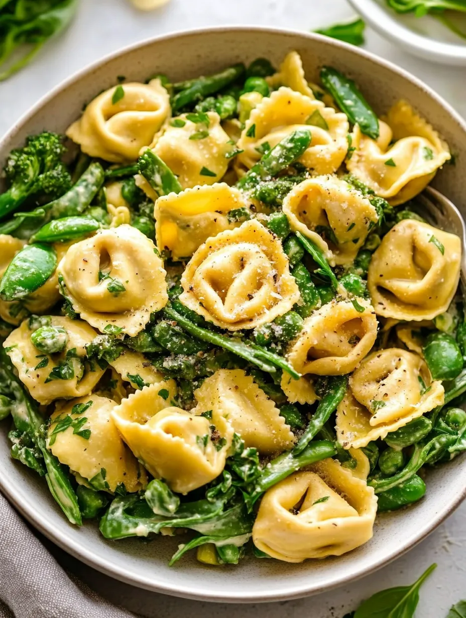 A bowl of pasta with green beans and cheese.