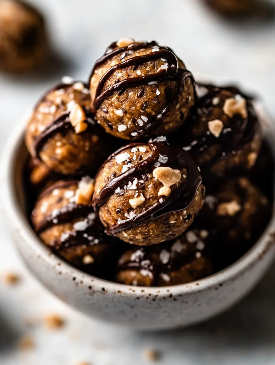 A bowl of chocolate covered balls with nuts.
