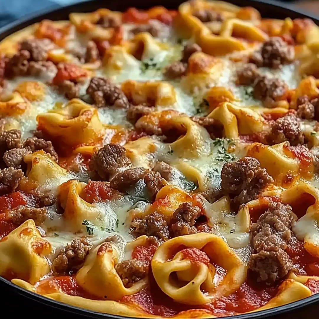 Pizza topped with noodles and lots of meat.