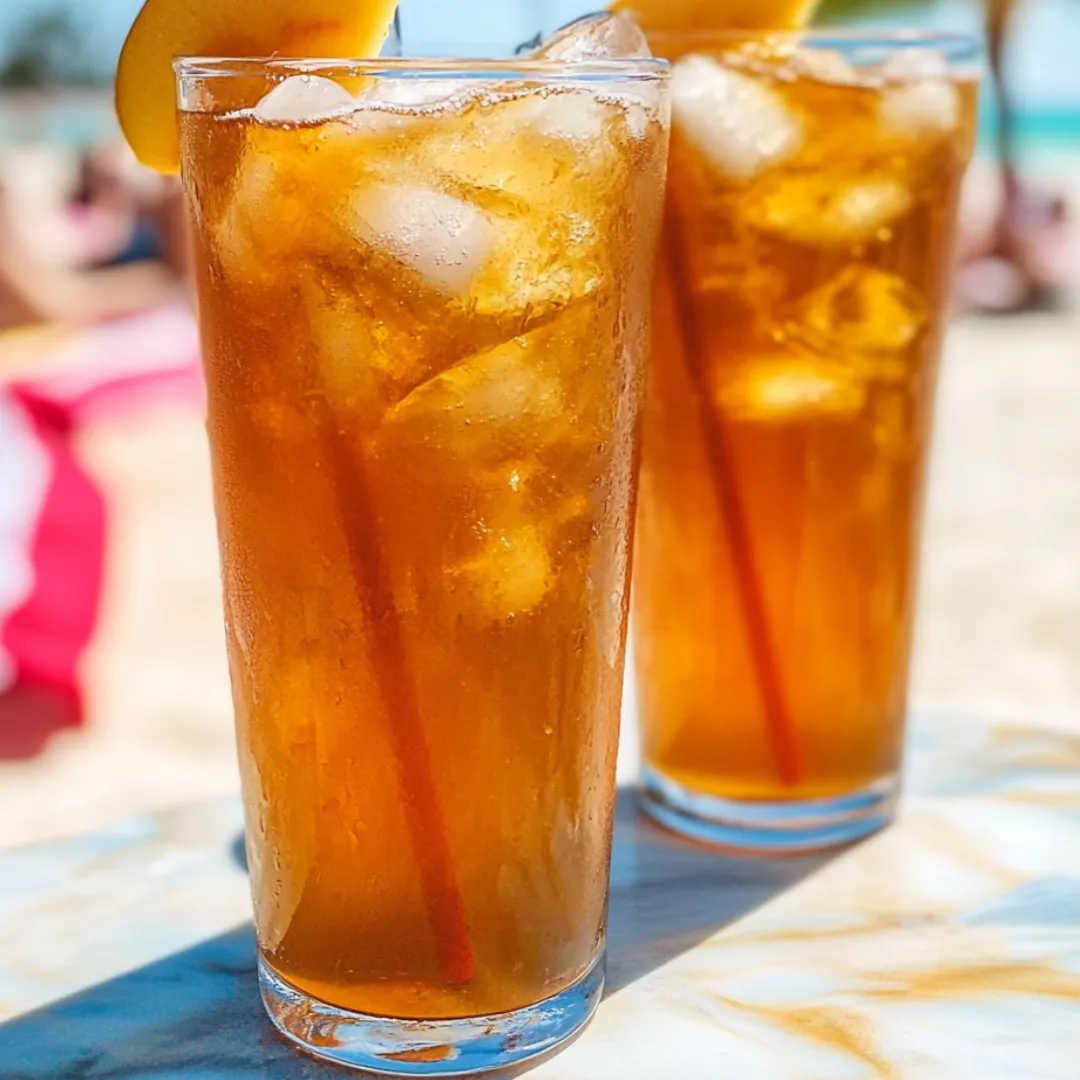 Iced tea in two glasses on a tabletop.