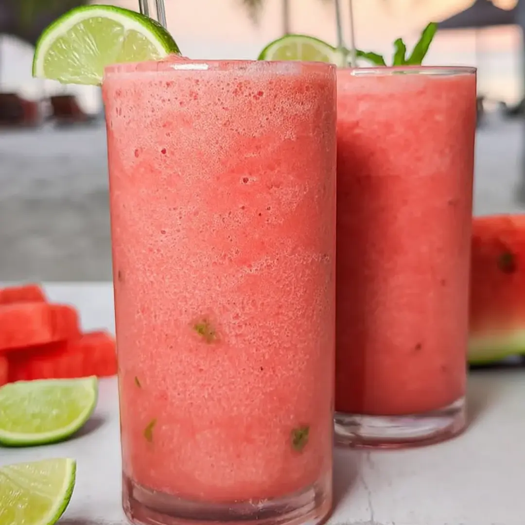 Bright pink fruit smoothie in two glasses.