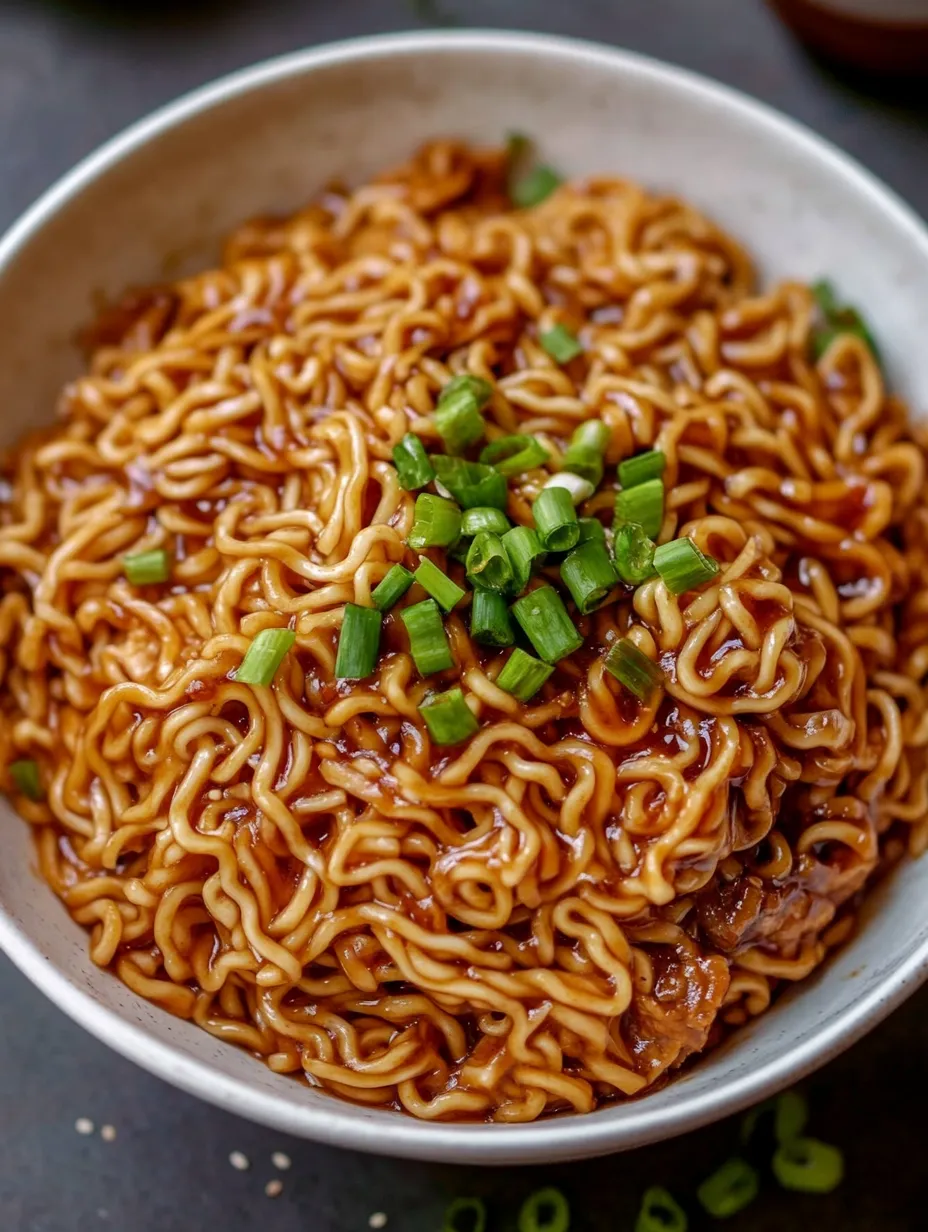 Noodles with piles of green onions on top.
