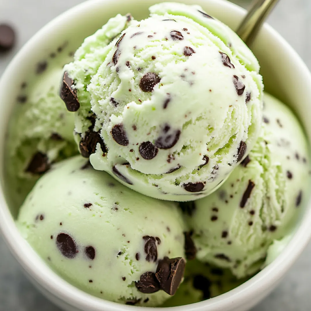 Chocolate chip-studded minty ice cream in a bowl.