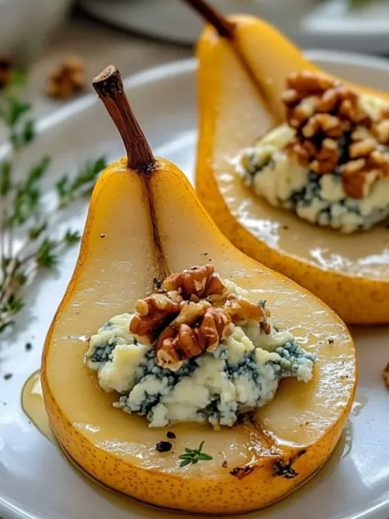 A wedge of pear topped with walnut on a plate.