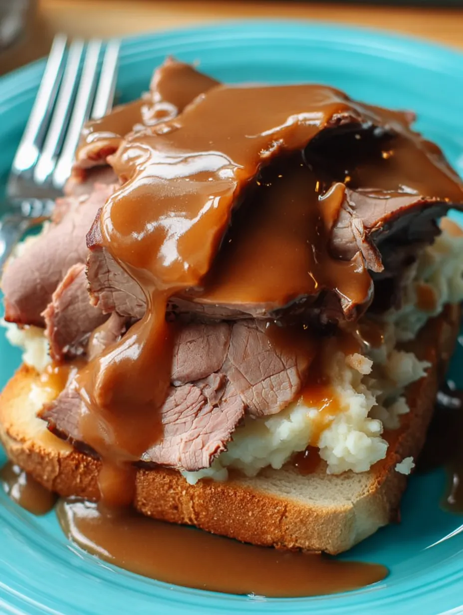 A plate heaped with potatoes and meat.