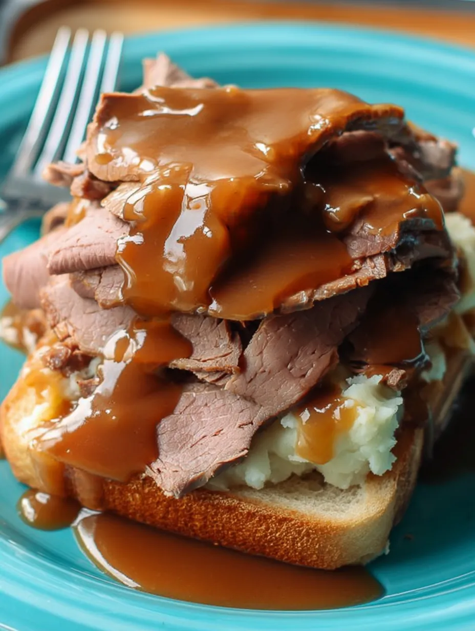 A plate topped with meat and gravy.