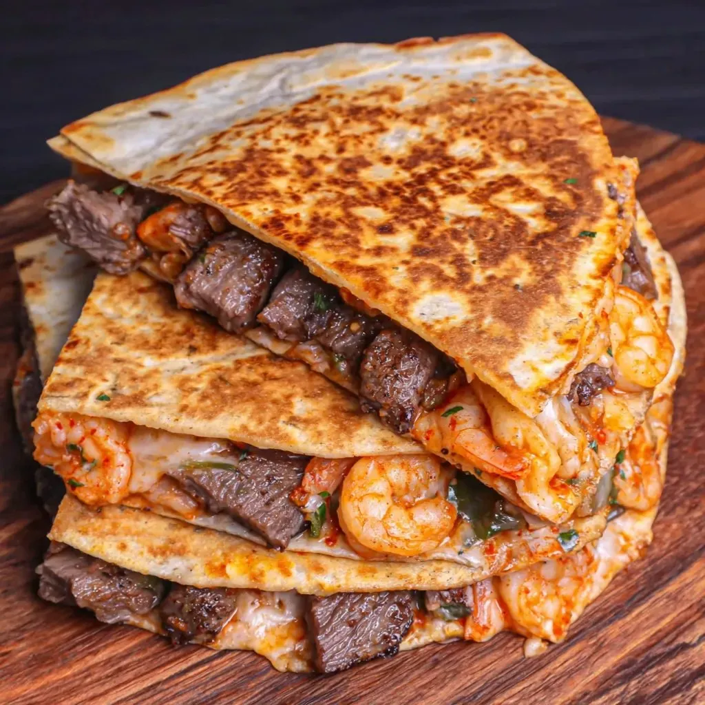 Stacked shrimp and beef quesadillas packed high.