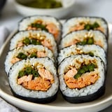 A plate of sushi with rice and seafood.