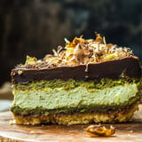 A slice of cake with chocolate and cream.