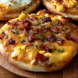 A plate of food with bacon and cheese.