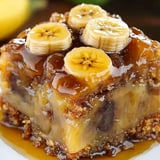 A slice of banana bread with bananas on top.