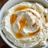 A bowl of food with a yellow sauce.