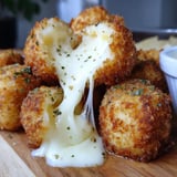 A cheese covered food item on a wooden table.
