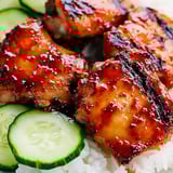 Jasmine rice with sliced cucumber on a plate.