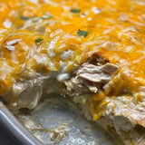 Warm chicken and cheese on a pizza slice.