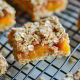 Close-up shot showing a chewy bar with oats and fruit.