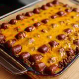 Chili and cheese baked in a glass pan, ready to serve.