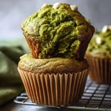 A fluffy green muffin topped with white chocolate.