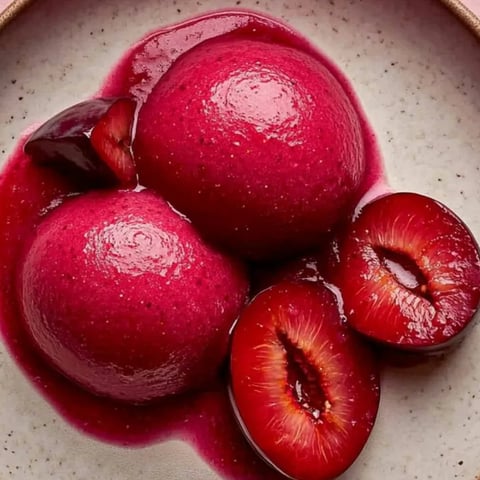 A plate of fruit with a cherry on top.